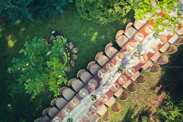 Big wedding dinner table in backyard view from above stock photo