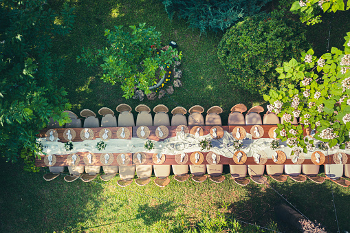 Big wedding dinner table in backyard view from above
