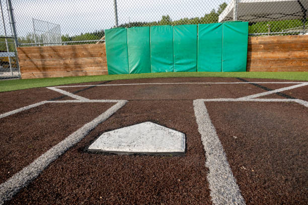 istock Angled view of a large, empty baseball field on a bright, sunny day 1400674220