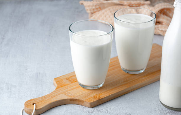 istock Kefir, buttermilk or yogurt in glass on light background. Probiotic cold fermented dairy drink. Gut health, fermented products, healthy gut flora concept. Copy space 1400676297