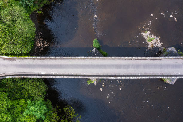istock Part of an old stone built bridge crossing a river 1400676328