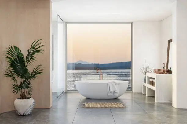 Photo of Luxury Bathroom Interior With Bathtub, Potted Plant And Sea View