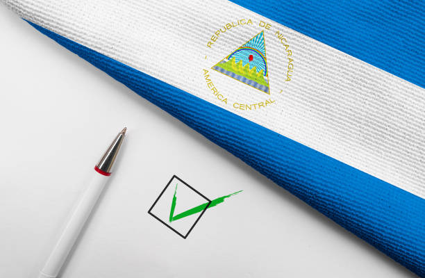 Pencil, Flag of Nicaragua and check mark on paper sheet