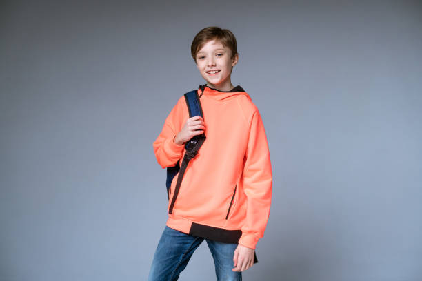 istock guy teenager posing with backpack on gray background 1400678518