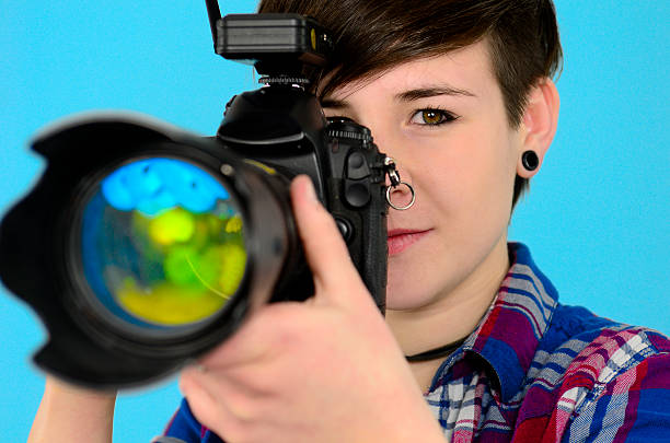 istock female photographer with digital SLR camera 140068074
