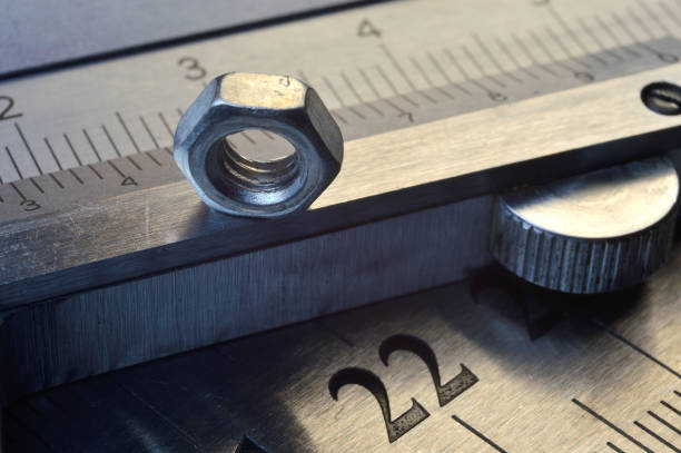 istock Accurate measuring tool caliper and metal ruler lie in place with nuts. close-up 1400682677