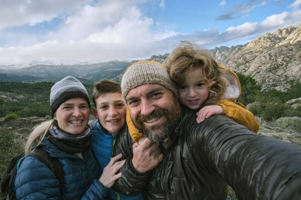 Family making a selfie in the mountain stock photo