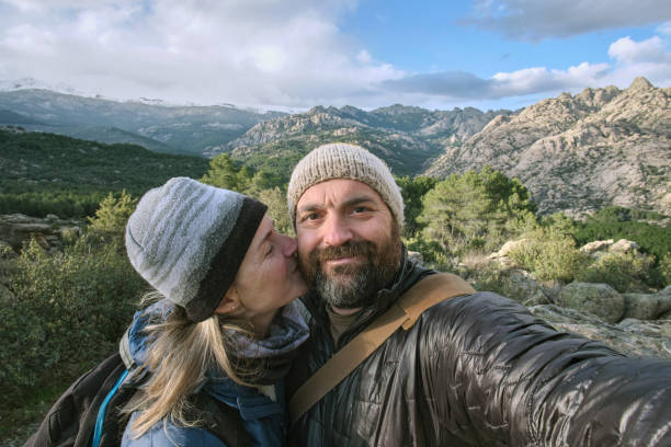 Couple taking a selfie in the mountains stock photo