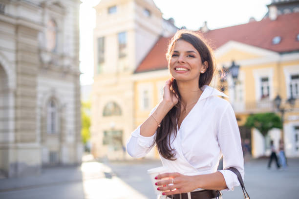 istock Young woman smiling at sunset 1400686176