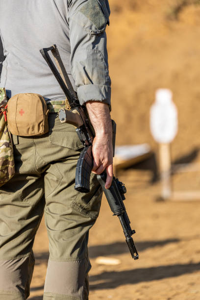 A soldier or mercenary holding an AK during a shooting drill on the range stock photo