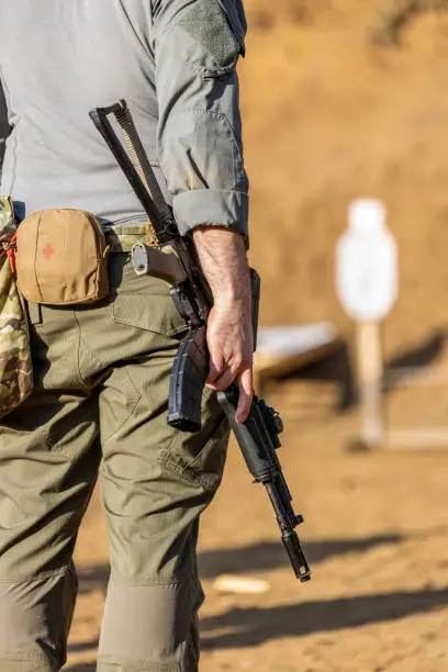 Photo of A soldier or mercenary holding an AK during a shooting drill on the range