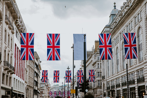 London, UK - April 28 2023: Regent Street lined with Union Jack flags ahead of the coronation of King Charles III.