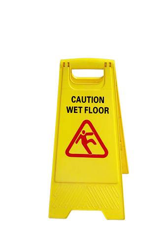 Yellow sign caution wet floor, isolated on white.