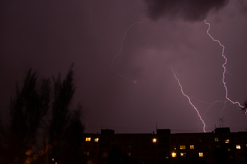Lightning at night with heavy rain and thunder over Ukraine, lightning over the city in the night sky over the house