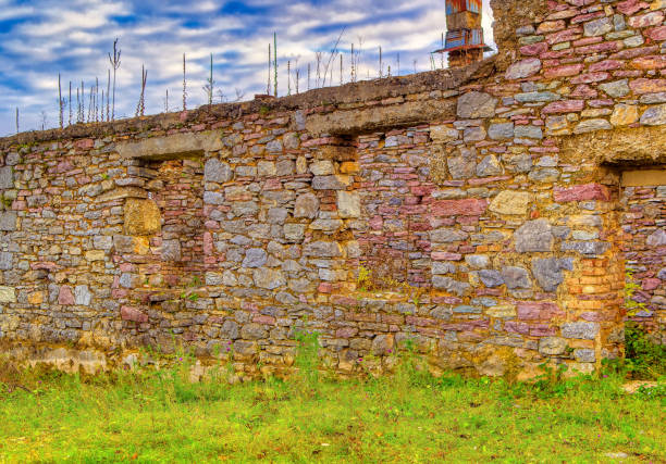 Old abandoned stone made house during cold cloudy day.