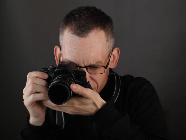 istock young man with photo camera 1400690390
