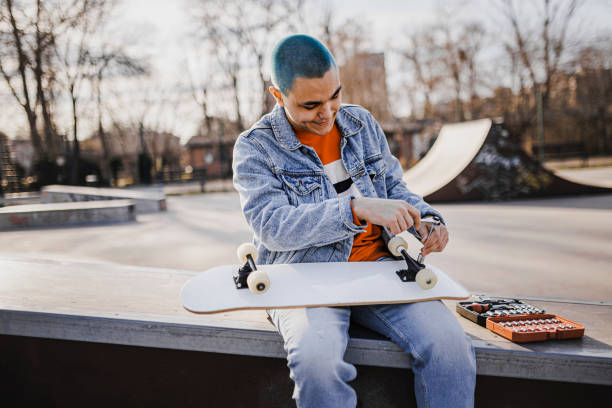 istock A man is making adjustments to his skateboard 1400691261