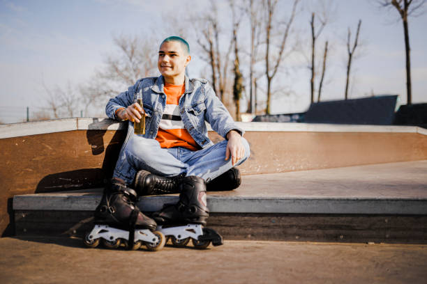 istock Young male hipster roller skating during spring day in the park 1400691569