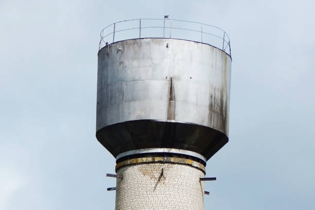 istock Old brick water tower against the sky 1400692382