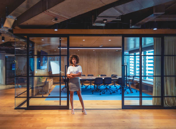 istock Successful woman standing confidently by her board room. 1400697492