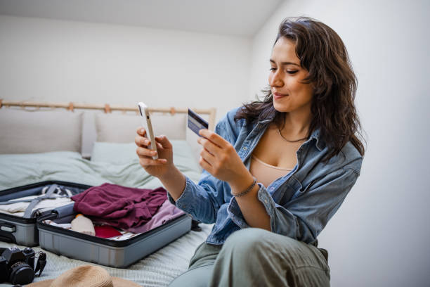 istock Woman using mobile phone to book travel reservation 1400698536