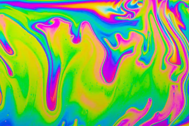 Photo of Psychedelic multicolored background abstract. Rainbow colors. patterns background. Photo macro shot of soap bubbles