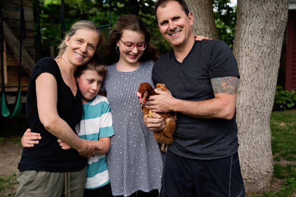 istock Family portrait with chicken in backyard. 1400700826
