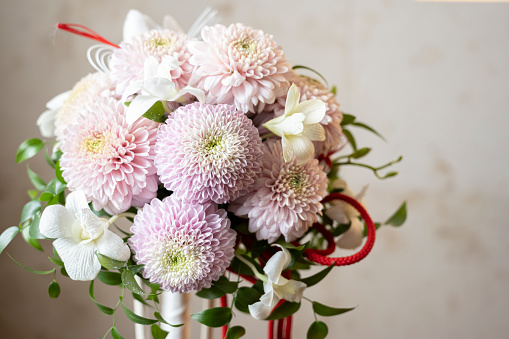 A bouquet that the bride has at a wedding reception.