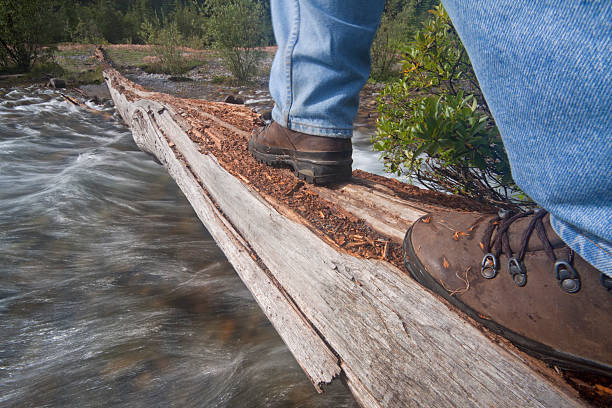 istock Person walking across a natural bridge over water 140070119