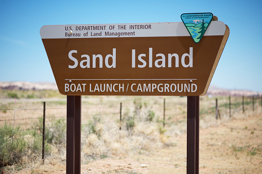 Bluff, Utah, USA - May 14, 2022: Sign for Sand Island boat launch and campground on Highway 191 just outside Bluff, Utah.