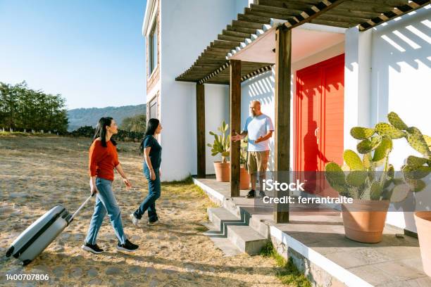 Female Friends Arrive At Vacation Rental Stock Photo - Download Image Now - Vacation Rental, Homestay - Lodging, Travel