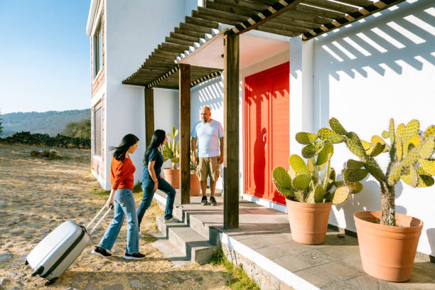 istock Female friends arrive at vacation rental 1400708389