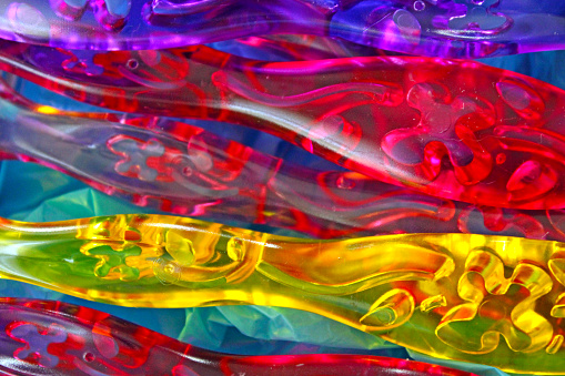 Abstract - Colored plastic with light showing through - rainbow background - looks like liquid plastic