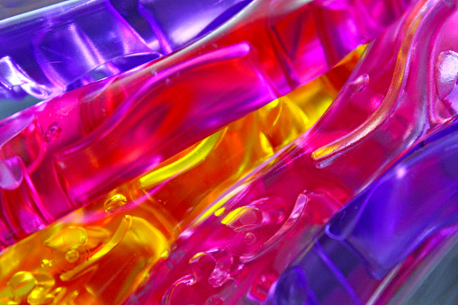 Abstract - Colored plastic with light showing through - rainbow background - looks like liquid plastic