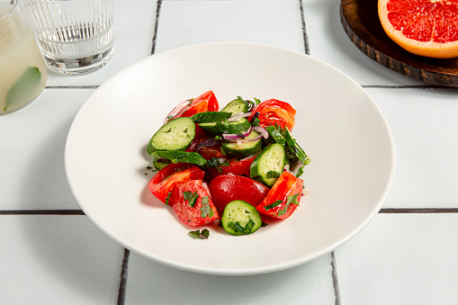 Salad with cucumber, tomato, onion and parsley.