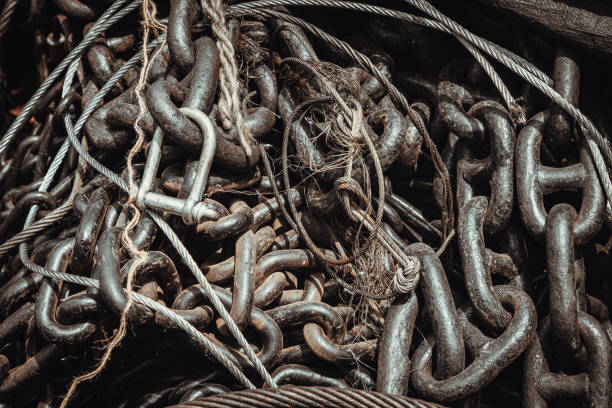 Old metal chain links stocked in store. Chains for heavy industrial use, Iron chain texture background, Selective Focus.