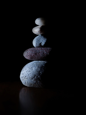 A group of stacked stones isolated on a black background.