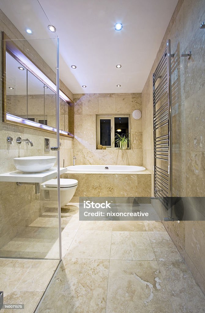 Modern Bathroom Modern, contemporary Luxury Bathroom with travertine tiles. Apartment Stock Photo