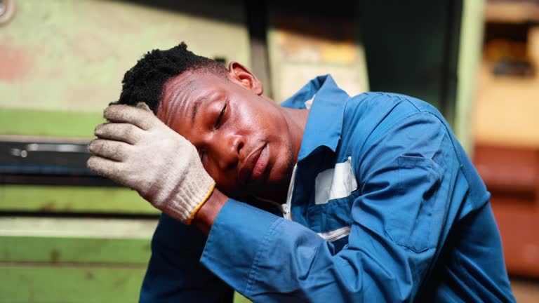 Slow motion Tired and hot. Portrait african american male engineer worker wearing safety hard hat helmet. Metal lathe industrial manufacturing factory