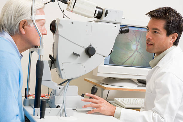 Doctor Checking Patient's Eyes Doctor Checking Patient's Eyes Using Retinal Scanner retina stock pictures, royalty-free photos & images