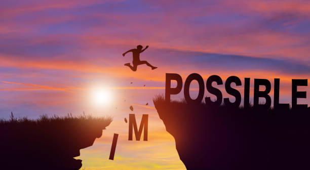 istock Silhouette man jumping over impossible and possible wording with cloud sky and sunrise. Positive mindset Concept. 1400724113