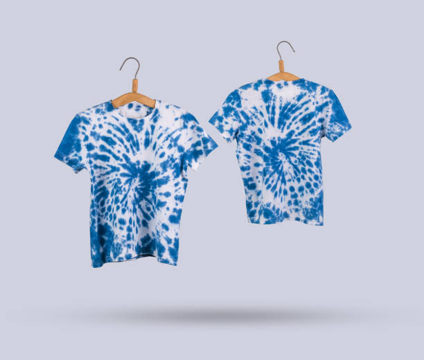 istock Two blue tie dye T-shirts on hangers on a light background. 1400724866