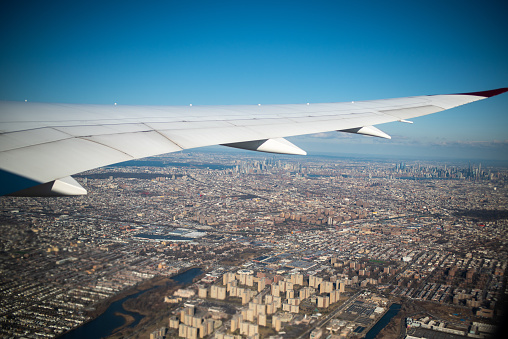 Airplane wing seen flying over New York City