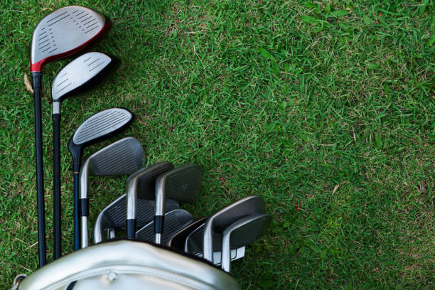 Closeup old golf bags on green.