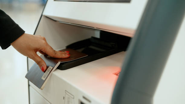 istock Young Asian Muslim Woman Wearing Face Mask Using a Self-service Check-in Booth. 1400737099