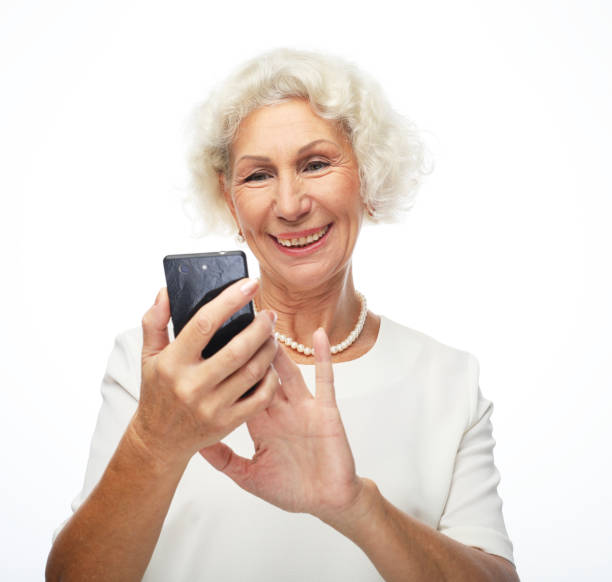 istock Old woman watching funny videos on internet. 1400737100
