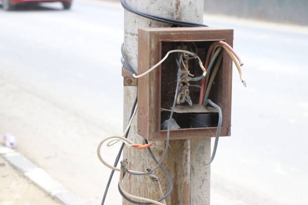istock Electric fuse box with broken wires or abandoned switch box on a streetlight 1400739223
