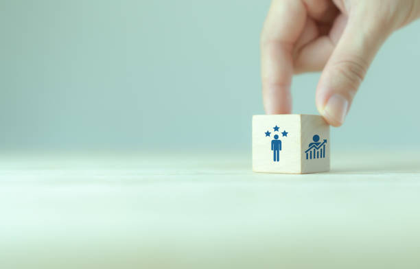 Personal development, growth mindset and promoted employee. Human resource management and training. Enhancing competency, self learning, experience. Wooden cubes with improvement and promoted icons.