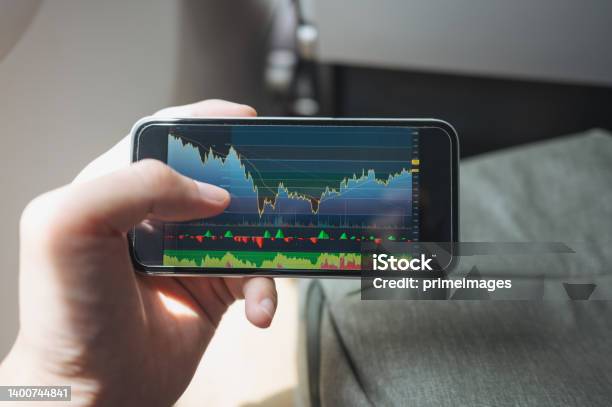 Business Asian Using Mobile Phone Smart Phone App Trading Stock Investment Checking Price Cryptocurrency And Using Online Trading From Flight Airplane Stock Photo - Download Image Now