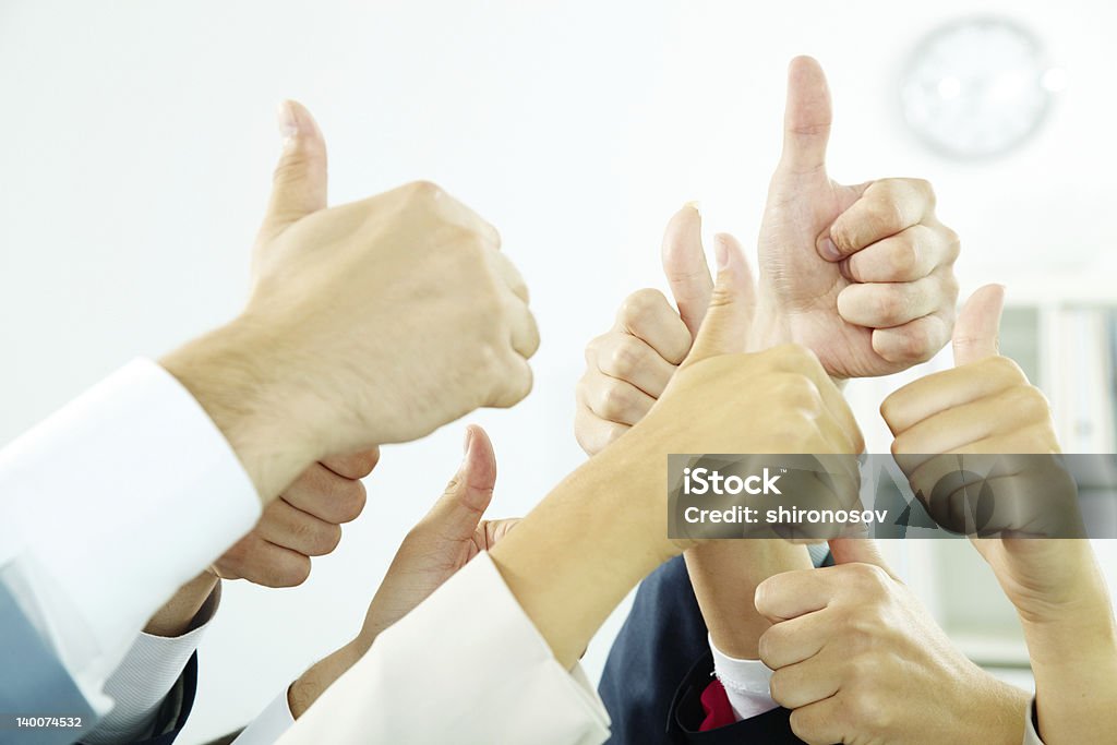 Voting Image of several human hands showing thumbs up in isolation Achievement Stock Photo